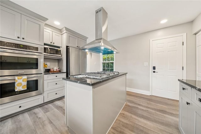 11 Sunset Ct, Cranberry Twp, PA 16066 - kitchen featuring island exhaust hood, stainless steel appliances, light wood-style floors, dark stone countertops, and recessed lighting