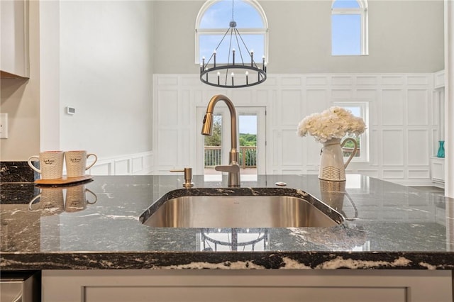 11 Sunset Ct, Cranberry Twp, PA 16066 - kitchen view of a decorative wall, dark stone countertops, and wainscoting