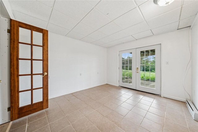 11 Sunset Ct, Cranberry Twp, PA 16066 - unfurnished room with french doors, light tile patterned floors, a drop ceiling, and a baseboard radiator