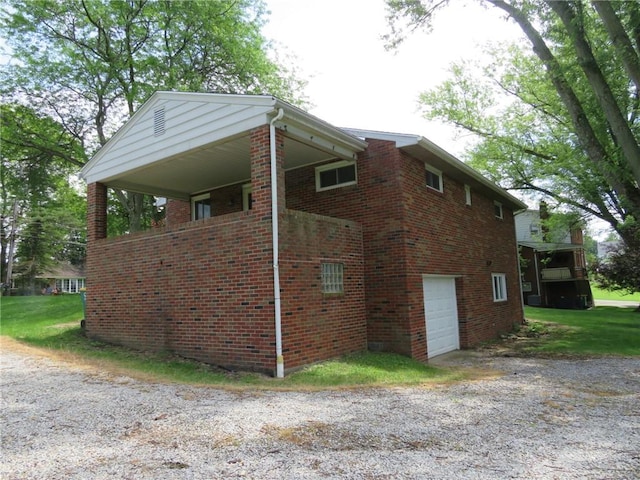 1332 Oakridge Rd, South Fayette, PA 15057 - view of home's exterior featuring a garage, brick siding, and gravel driveway