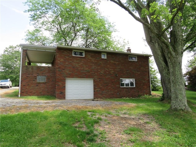 1332 Oakridge Rd, South Fayette, PA 15057 - view of side of home featuring driveway, a garage, brick siding, and a lawn