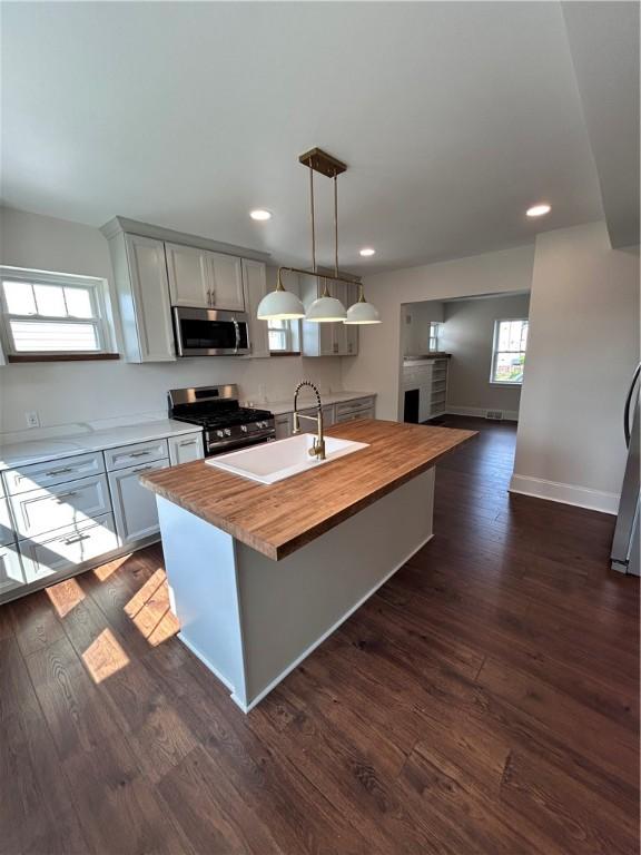 252 Hudson Ave, City Of Greensburg, PA 15601 - kitchen with appliances with stainless steel finishes, wood counters, a center island with sink, healthy amount of natural light, and recessed lighting