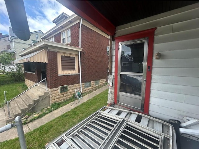 2607 Spring St, Arlington, PA 15210 - view of exterior entry featuring brick siding