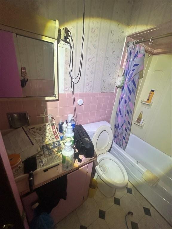2607 Spring St, Arlington, PA 15210 - full bath with wallpapered walls, shower / bath combo, tile walls, tile patterned flooring, and a wainscoted wall