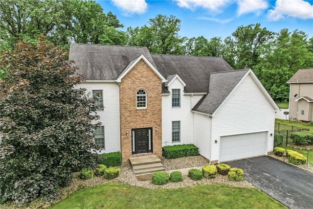 1603 Lori Ln, Hermitage, PA 16148 - view of front facade with driveway, brick siding, an attached garage, and a shingled roof