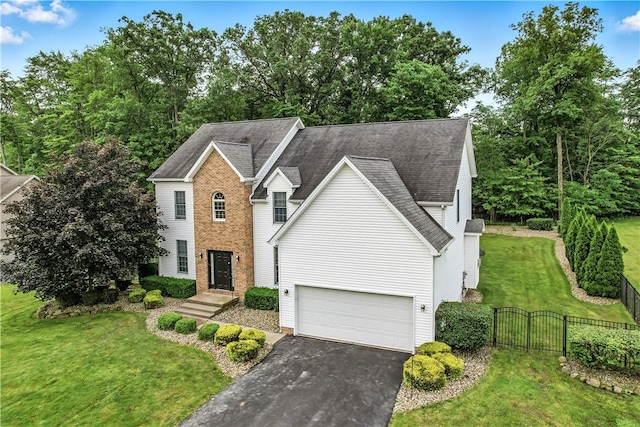 1603 Lori Ln, Hermitage, PA 16148 - traditional home featuring driveway, a gate, roof with shingles, and view of wooded area
