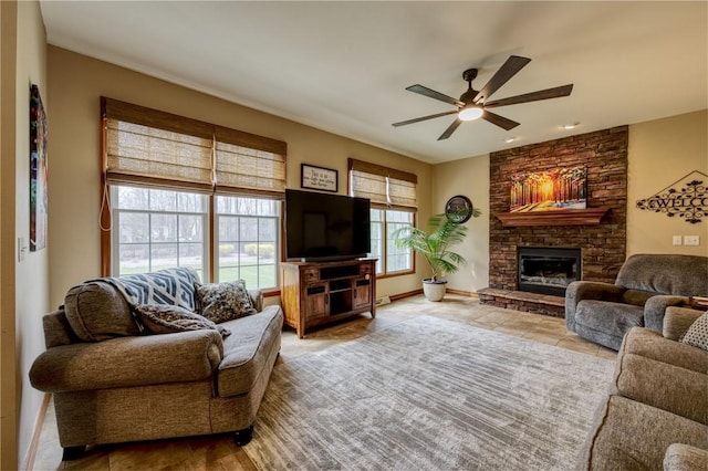 1603 Lori Ln, Hermitage, PA 16148 - tiled living room featuring a ceiling fan and a stone fireplace