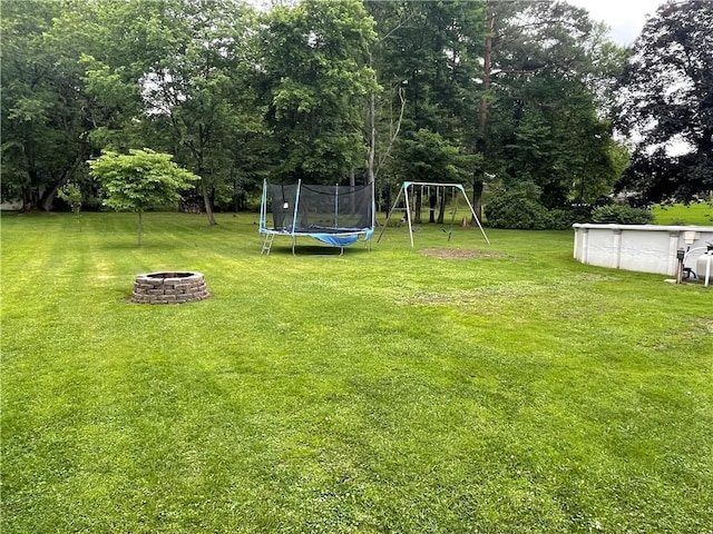 2568 Mercer St, Sandy Lake Boro, PA 16145 - view of green lawn featuring a fire pit, a trampoline, a playground, and an outdoor pool