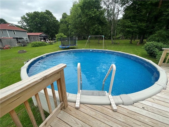 2568 Mercer St, Sandy Lake Boro, PA 16145 - swimming pool with a trampoline, a yard, and view of scattered trees