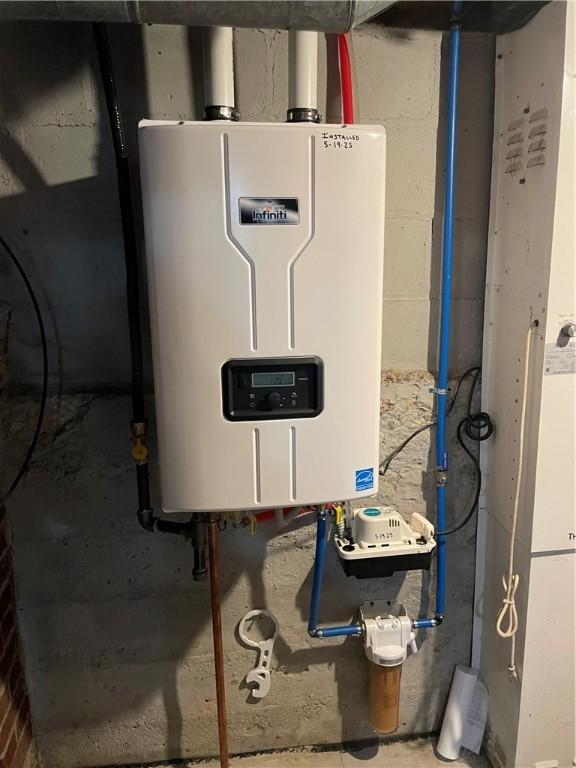 2568 Mercer St, Sandy Lake Boro, PA 16145 - utility room featuring tankless water heater