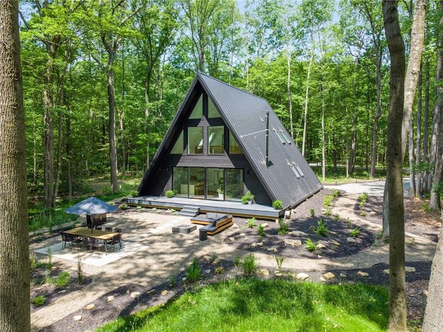 3019 Oak Ridge Ln, Saltlick Twp, PA 15622 - back of property with a metal roof and a wooded view