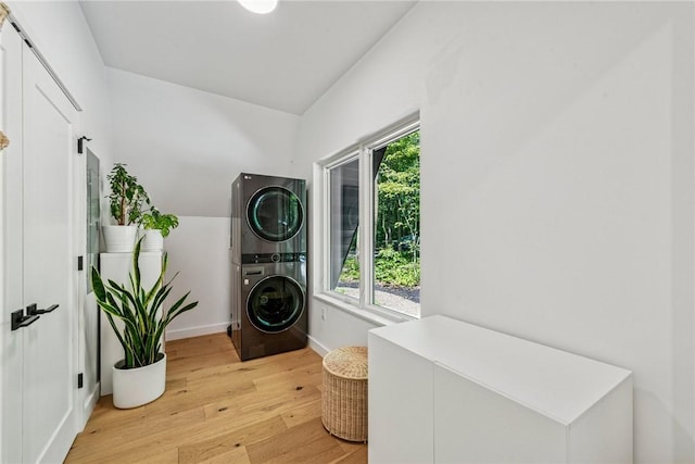 3019 Oak Ridge Ln, Saltlick Twp, PA 15622 - washroom featuring stacked washer and clothes dryer and light wood-style flooring