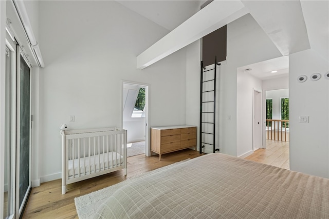 3019 Oak Ridge Ln, Saltlick Twp, PA 15622 - bedroom with light wood-style floors, a towering ceiling, and a barn door