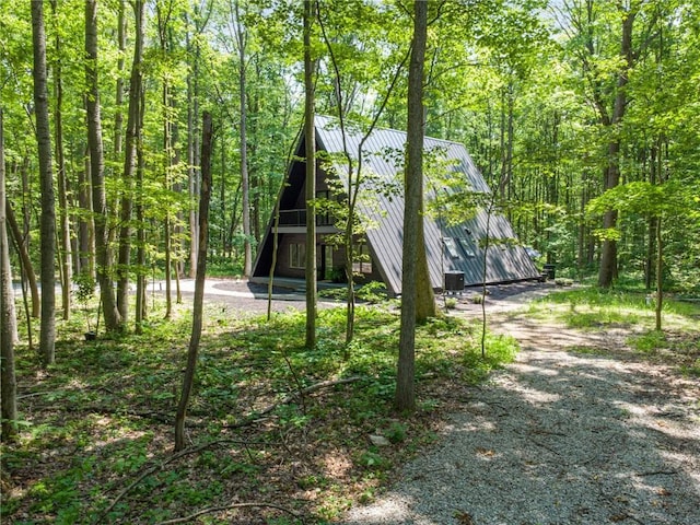 3019 Oak Ridge Ln, Saltlick Twp, PA 15622 - rear view of property with a barn, a metal roof, dirt driveway, and a view of trees