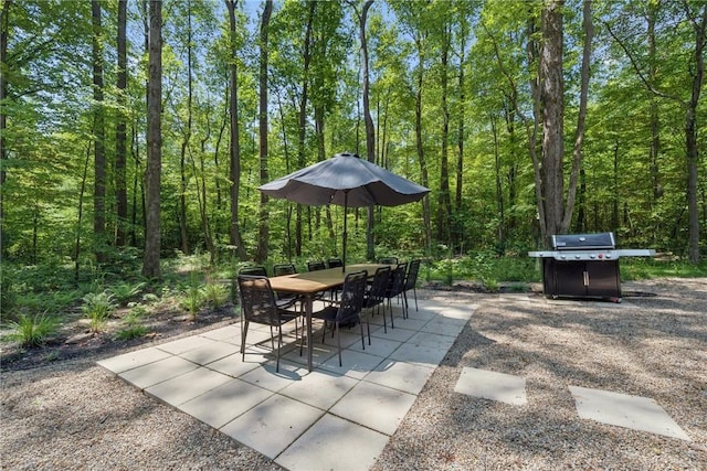 3019 Oak Ridge Ln, Saltlick Twp, PA 15622 - view of patio / terrace featuring a grill, a view of trees, and outdoor dining space