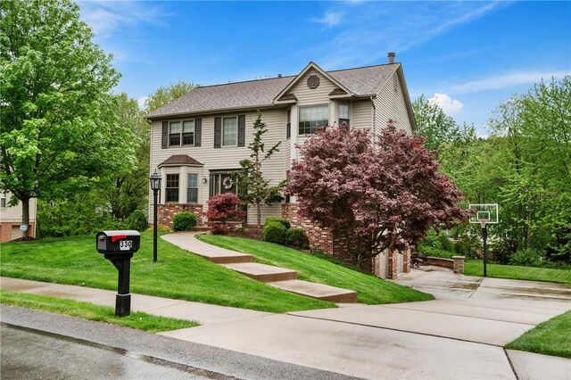 330 Warrick Dr, Seven Fields Boro, PA 16046 - view of front of house featuring a front lawn, concrete driveway, an attached garage, and a chimney