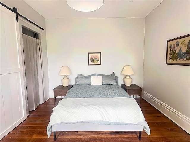 389 Rices Landing Rd, Luzerne Twp, PA 15433 - bedroom featuring a barn door and dark wood finished floors
