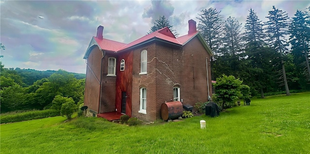 389 Rices Landing Rd, Luzerne Twp, PA 15433 - view of property exterior featuring a chimney, oil tank, and a lawn