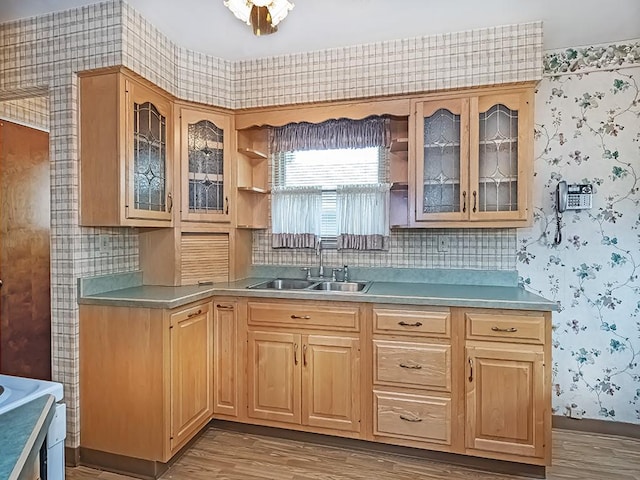 127 Pleasant Hills Blvd, Pleasant Hills, PA 15236 - kitchen with wallpapered walls, wood finished floors, glass insert cabinets, light countertops, and light brown cabinets