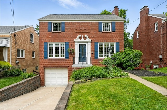 717 Kewanna Ave, Mt Lebanon, PA 15234 - colonial inspired home featuring driveway, a front lawn, brick siding, and a garage