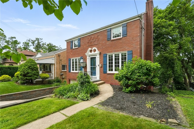 717 Kewanna Ave, Mt Lebanon, PA 15234 - view of front of house featuring brick siding, a chimney, and a front yard
