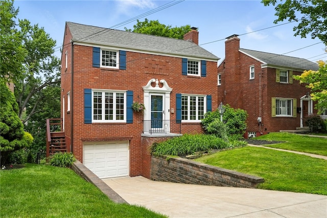 717 Kewanna Ave, Mt Lebanon, PA 15234 - colonial house with driveway, brick siding, a front lawn, an attached garage, and a chimney