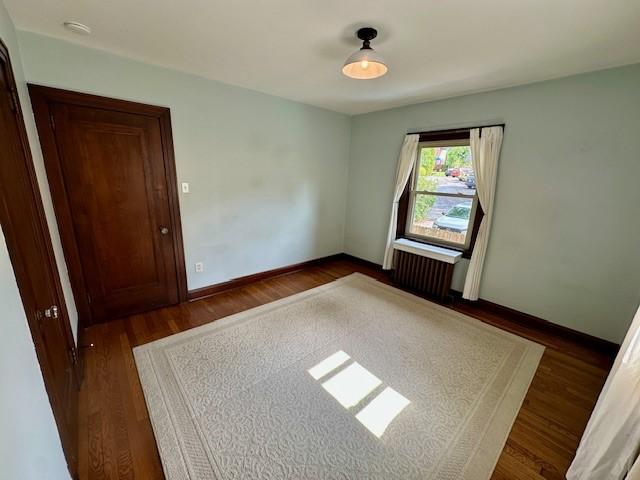 111 Race St, Regent Square, PA 15218 - unfurnished room with wood finished floors, radiator, and a smoke detector