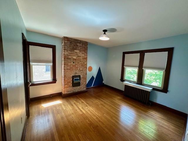 111 Race St, Regent Square, PA 15218 - unfurnished living room with radiator, healthy amount of natural light, wood finished floors, and heating unit