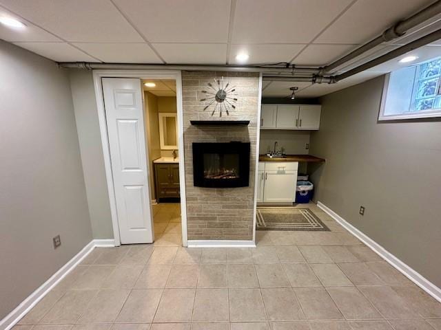 111 Race St, Regent Square, PA 15218 - basement featuring light tile patterned floors, a large fireplace, and a drop ceiling