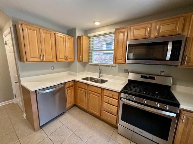 111 Race St, Regent Square, PA 15218 - kitchen featuring appliances with stainless steel finishes, light tile patterned floors, and light countertops