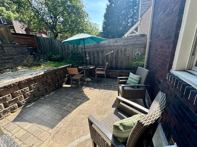 111 Race St, Edgewood, PA 15218 - fenced backyard featuring a patio and outdoor dining space
