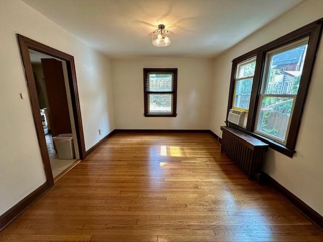 111 Race St, Regent Square, PA 15218 - empty room featuring radiator, healthy amount of natural light, and wood finished floors