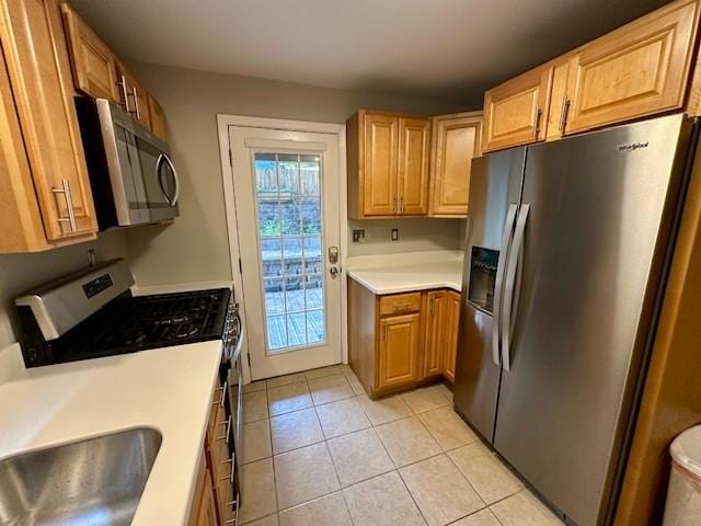 111 Race St, Edgewood, PA 15218 - kitchen with stainless steel appliances, light tile patterned flooring, and light countertops