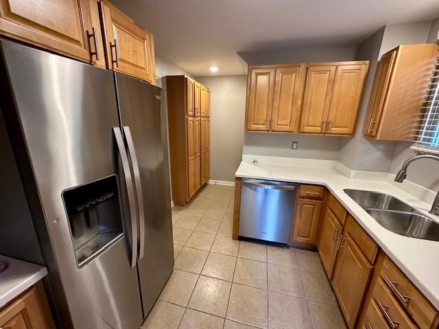 111 Race St, Edgewood, PA 15218 - kitchen featuring appliances with stainless steel finishes, recessed lighting, light tile patterned floors, light countertops, and brown cabinetry