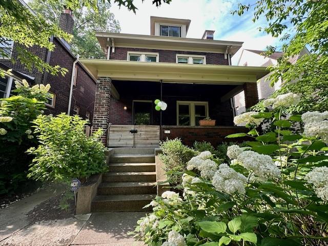 111 Race St, Edgewood, PA 15218 - american foursquare style home featuring a porch and brick siding