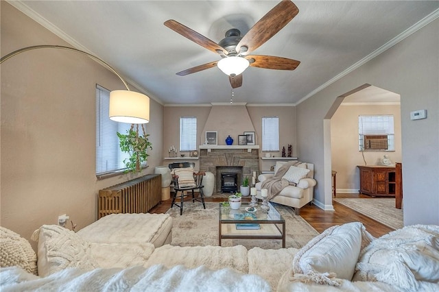 725 Dunster St, Brookline, PA 15226 - living room with radiator heating unit, wood finished floors, a ceiling fan, arched walkways, and ornamental molding