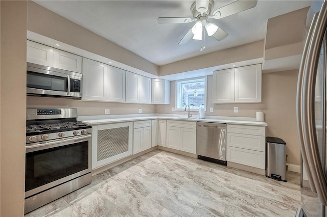 725 Dunster St, Brookline, PA 15226 - kitchen featuring stainless steel appliances, light countertops, light marble finish flooring, ceiling fan, and white cabinetry