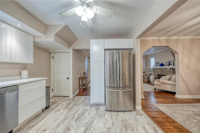 725 Dunster St, Brookline, PA 15226 - kitchen with appliances with stainless steel finishes, ceiling fan, white cabinets, arched walkways, and light wood-type flooring