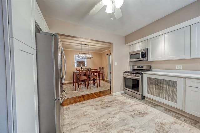 725 Dunster St, Brookline, PA 15226 - kitchen featuring appliances with stainless steel finishes, white cabinets, light countertops, ceiling fan, and crown molding