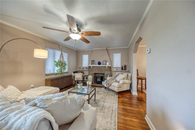 725 Dunster St, Brookline, PA 15226 - living room featuring radiator, ceiling fan, wood finished floors, ornamental molding, and a fireplace