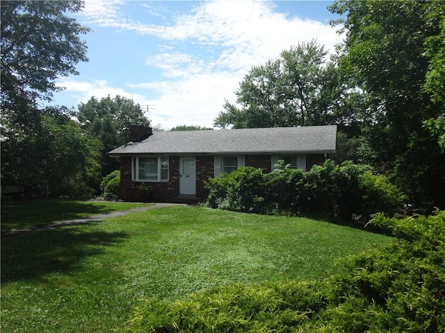 110 Raymond Ave, Luzerne Twp, PA 15417 - view of front of house featuring a front yard, a chimney, and brick siding