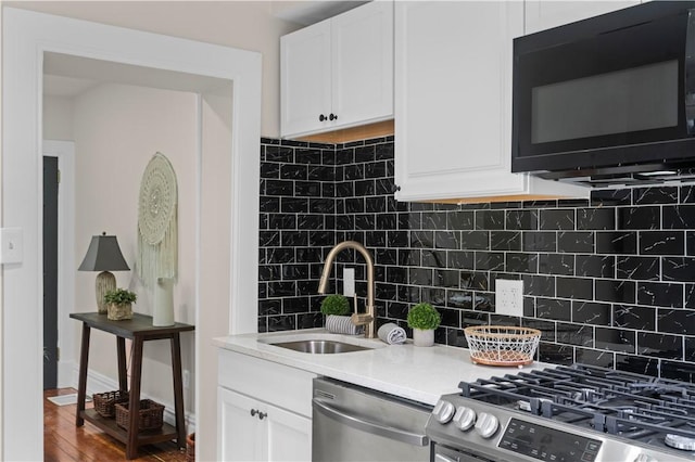 927 Greenfield Ave, Greenfield, PA 15217 - kitchen featuring stainless steel appliances, backsplash, white cabinets, and light countertops