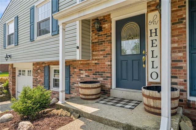 425 Sandy Dr, Shaler, PA 15116 - view of exterior entry with brick siding, a garage, and covered porch