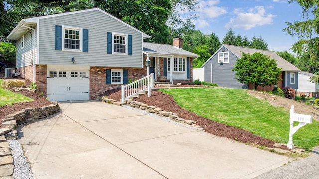 425 Sandy Dr, Shaler, PA 15116 - tri-level home with brick siding, a garage, concrete driveway, a front yard, and a chimney