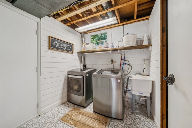 425 Sandy Dr, Shaler, PA 15116 - laundry area featuring separate washer and dryer, tile patterned floors, wood walls, and concrete block wall