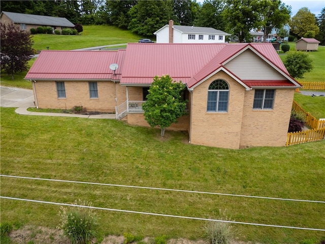 246 Johnston Rd, Bentleyville, PA 15314 - rear view of house featuring brick siding, a metal roof, and a lawn