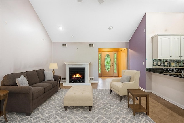 246 Johnston Rd, Bentleyville, PA 15314 - living area featuring a warm lit fireplace and high vaulted ceiling