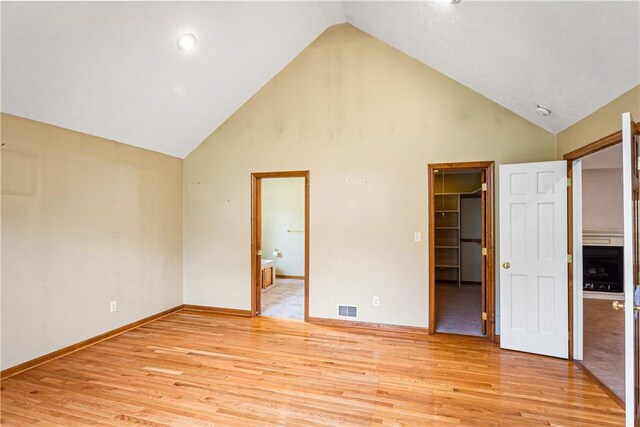 246 Johnston Rd, Bentleyville, PA 15314 - unfurnished bedroom with light wood-style floors, high vaulted ceiling, a walk in closet, ensuite bath, and a closet