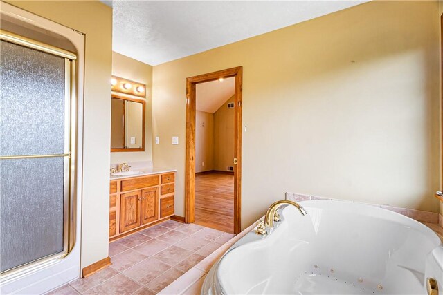 246 Johnston Rd, Bentleyville, PA 15314 - bathroom featuring a whirlpool tub, vanity, a stall shower, and tile patterned flooring