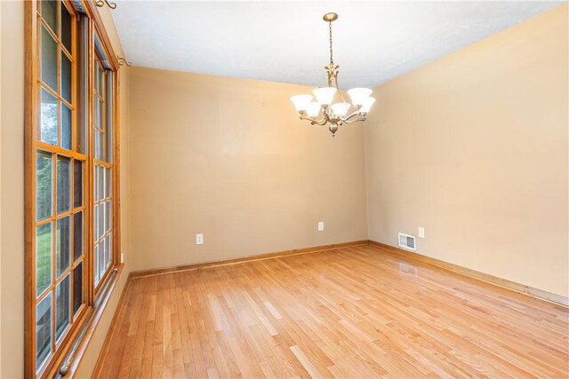 246 Johnston Rd, Bentleyville, PA 15314 - spare room featuring a chandelier and light wood-style flooring
